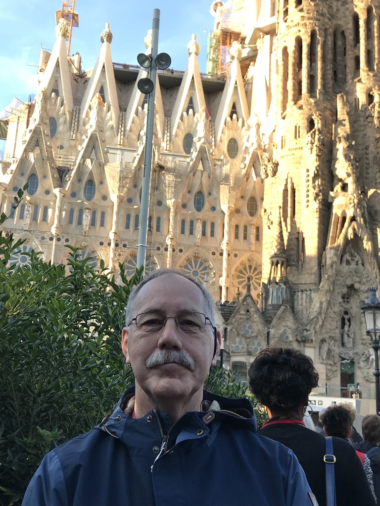 A person standing in front of a building

Description automatically generated