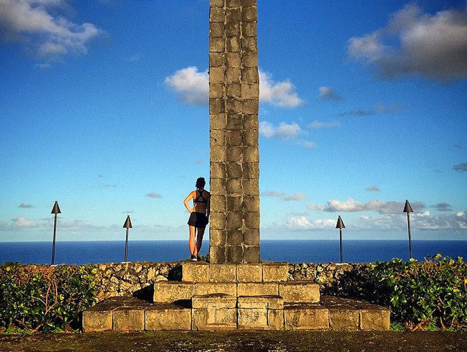 A group of people standing in front of a tower

Description automatically generated