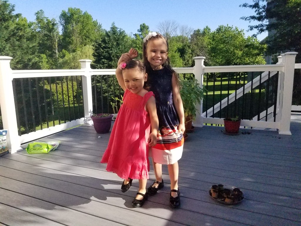 A person standing next to a fence

Description automatically generated