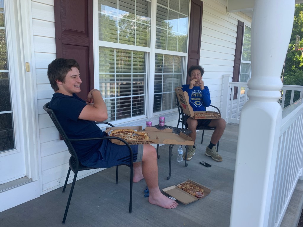 A person standing next to a window

Description automatically generated