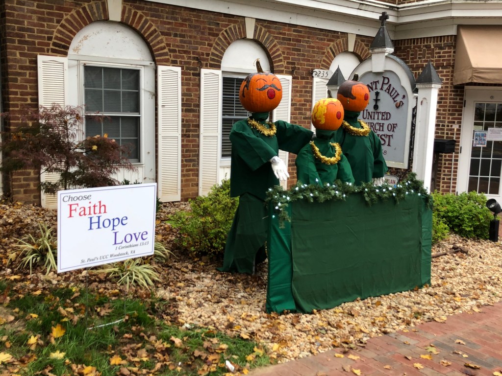 A person standing in front of a brick building

Description automatically generated