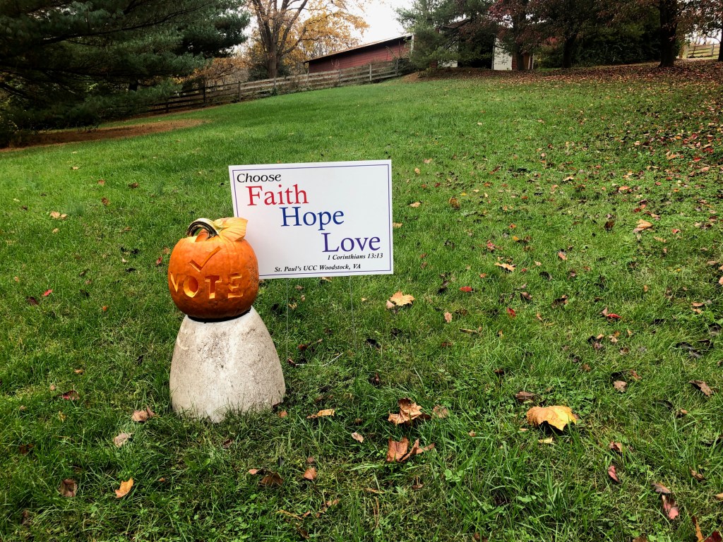 A fire hydrant sitting in the grass

Description automatically generated